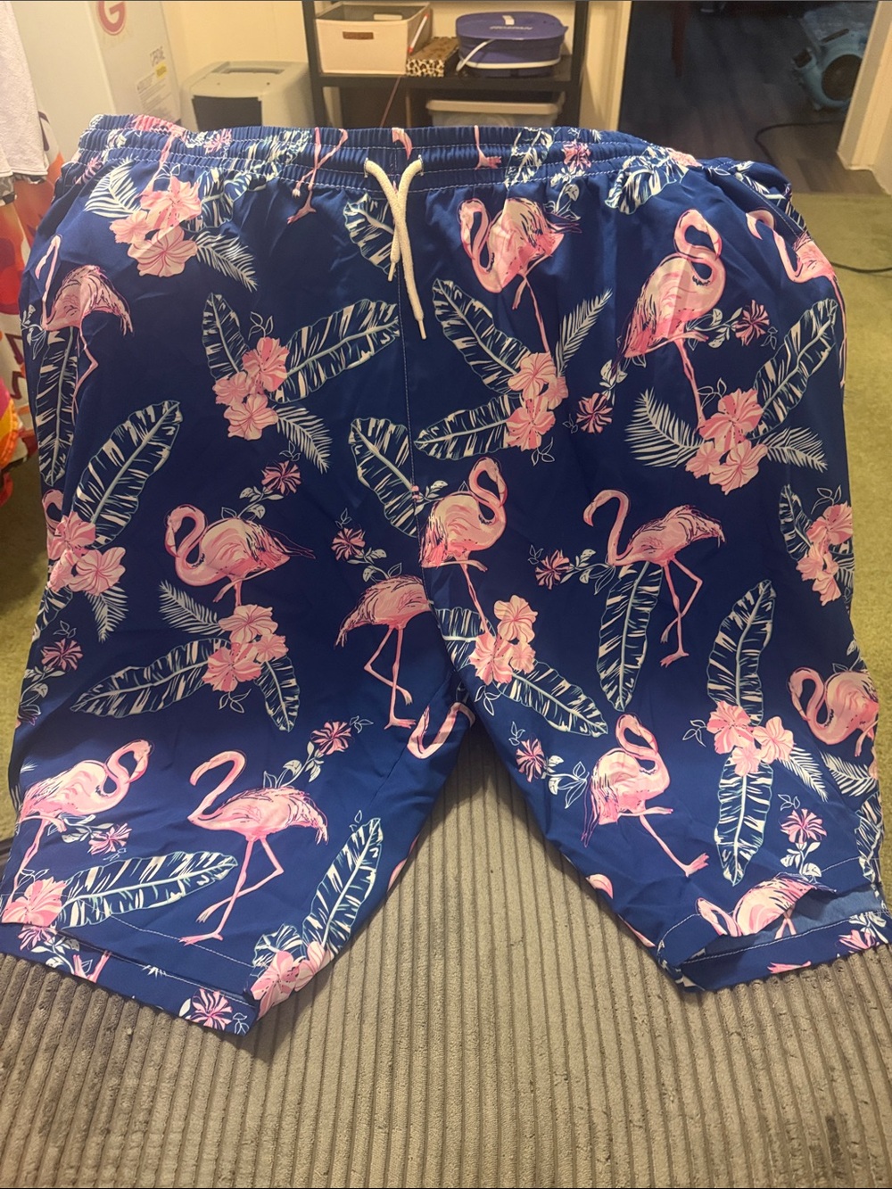 23 in hip to hip stretch to 30inMen's Blue Flamingo Print Swim Shorts